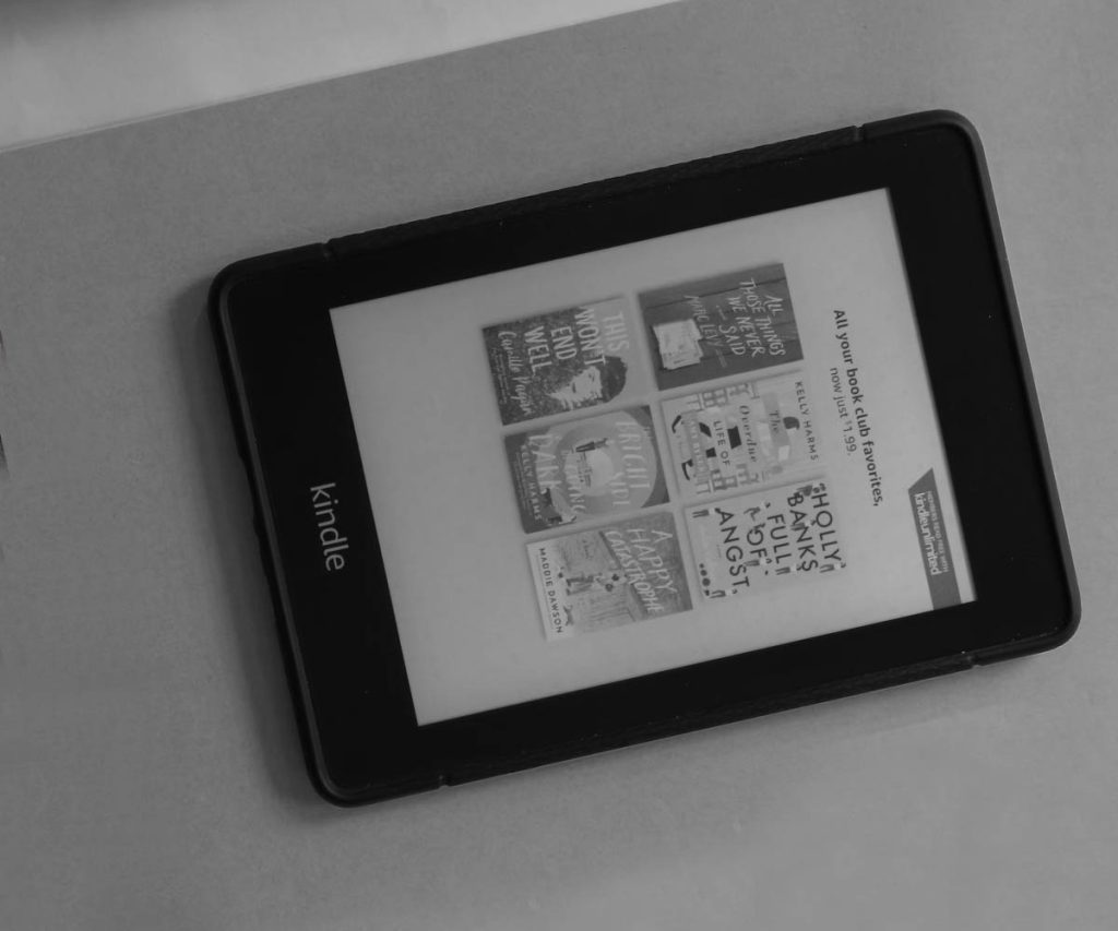 A kindle device sits on the table waiting for the next book adventure