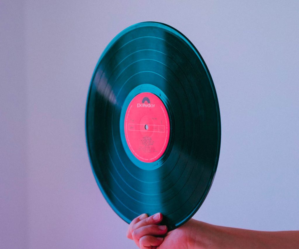Someone holding an old vinyl record